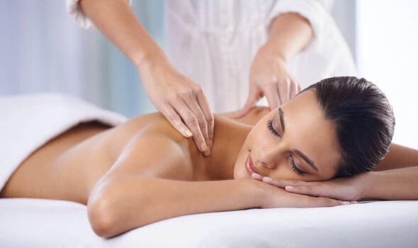 relaxed woman receiving shoulder massage