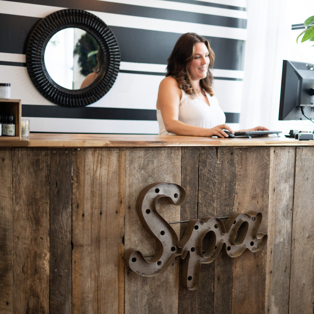 Small owner behind the front desk of a day spa in Nashville, TN
