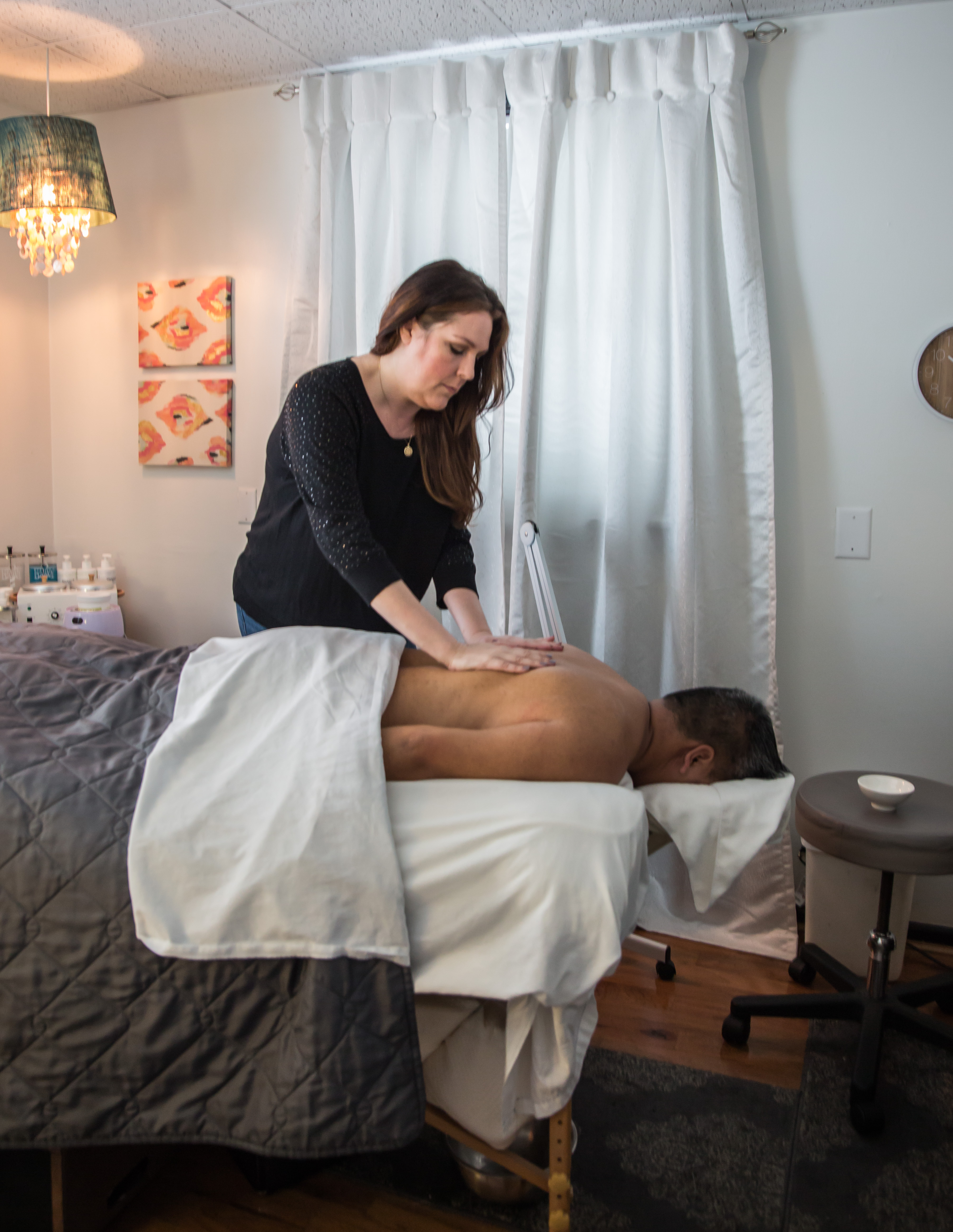 Massage therapist giving a back massage at a day spa