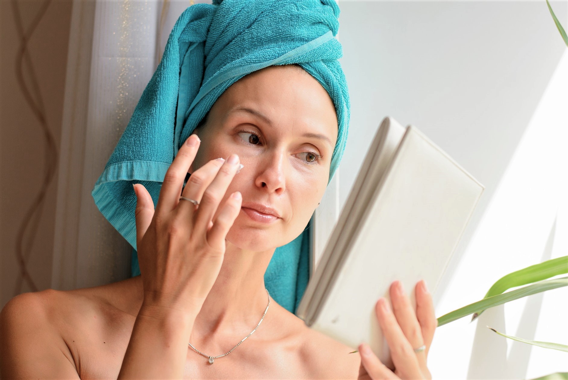 Woman putting anti-aging creams on her face