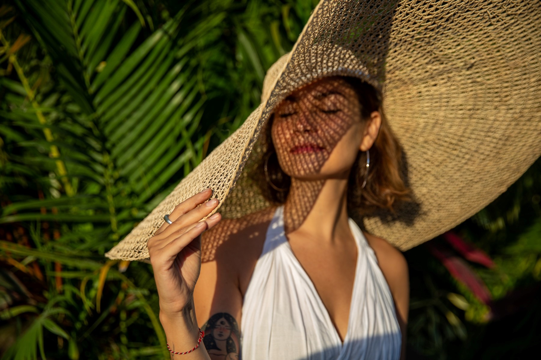 Woman in a sun hat with radiant skin