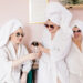 Group of friends enjoying a spa day in Nashville, relaxing in robes and sipping champagne during a girls' getaway at Urban Oasis Nashville Day Spa.