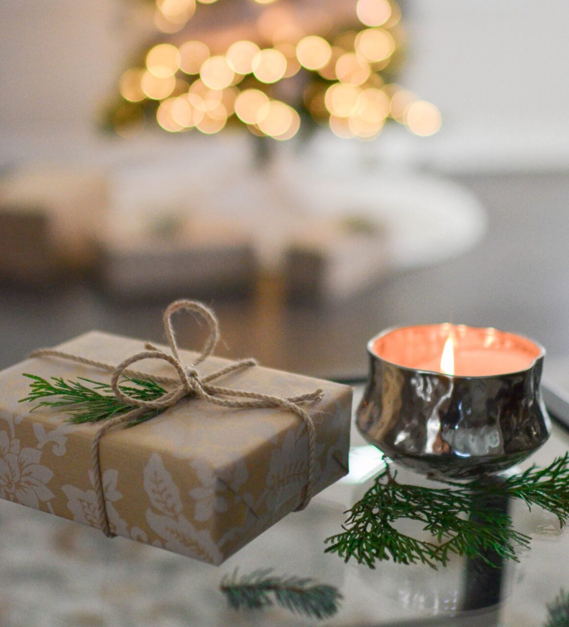 A gift box and candle. Wishing you happy holidays from Urban Oasis Day Spa!