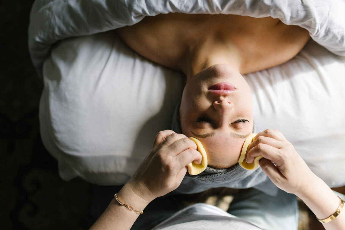 Woman receiving a relaxing facial treatment at Urban Oasis Nashville spa