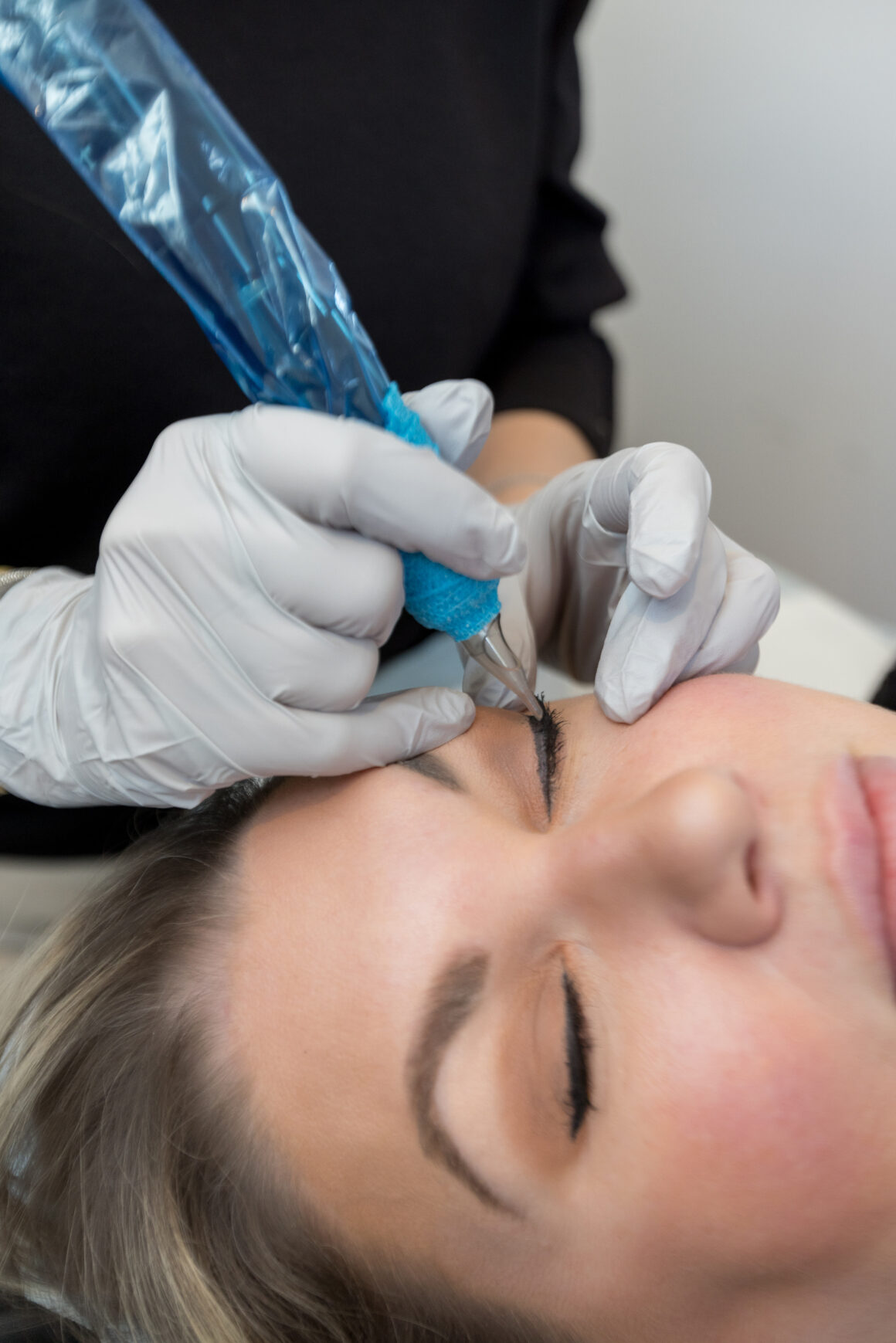 Woman receiving a permanent eyeliner treatment at a professional beauty studio- Urban Oasis Nashville