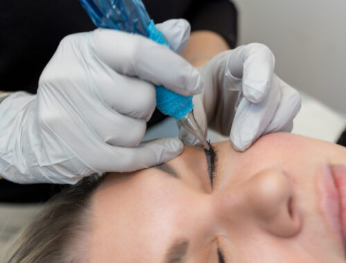 Woman receiving a permanent eyeliner treatment at a professional beauty studio- Urban Oasis Nashville