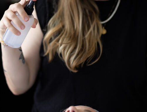 A woman relaxing in a spa setting, receiving a luxurious massage while her skin glows with hydration. The dimly lit, serene environment enhances the self-care experience, emphasizing the connection between massage and skincare in Nashville and body wellness and radiant skin.