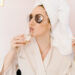 Woman in a spa robe drinking prosecco and relaxing during a spa day at Urban Oasis Nashville.