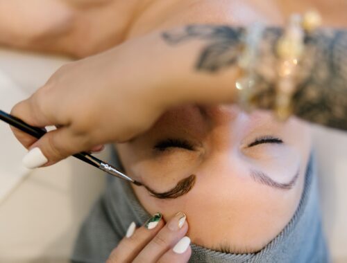 Woman receiving brow tint, brow lamination and lash lift combo treatment at Urban Oasis Nashville spa