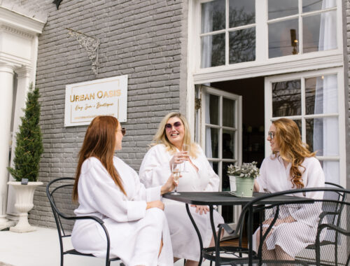 Three women enjoying a spa day with champagne before their treatments at a Nashville day spa