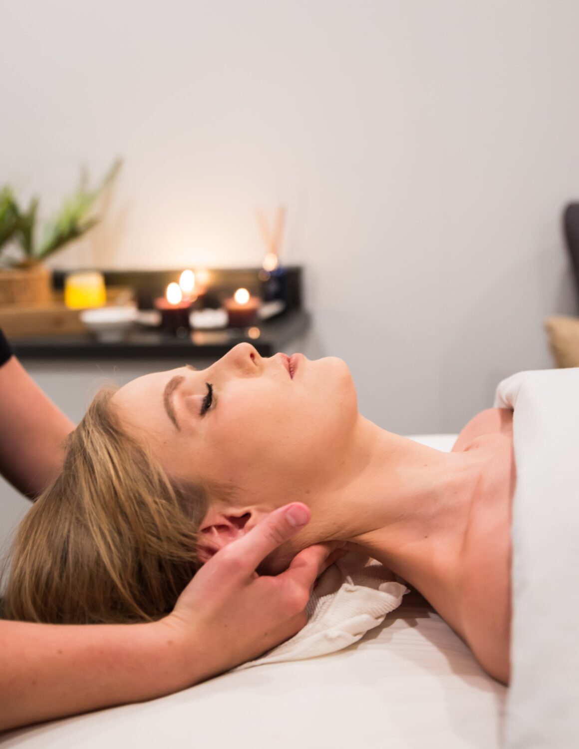 Woman receiving a relaxing massage at Urban Oasis Nashville as part of a fall spa membership