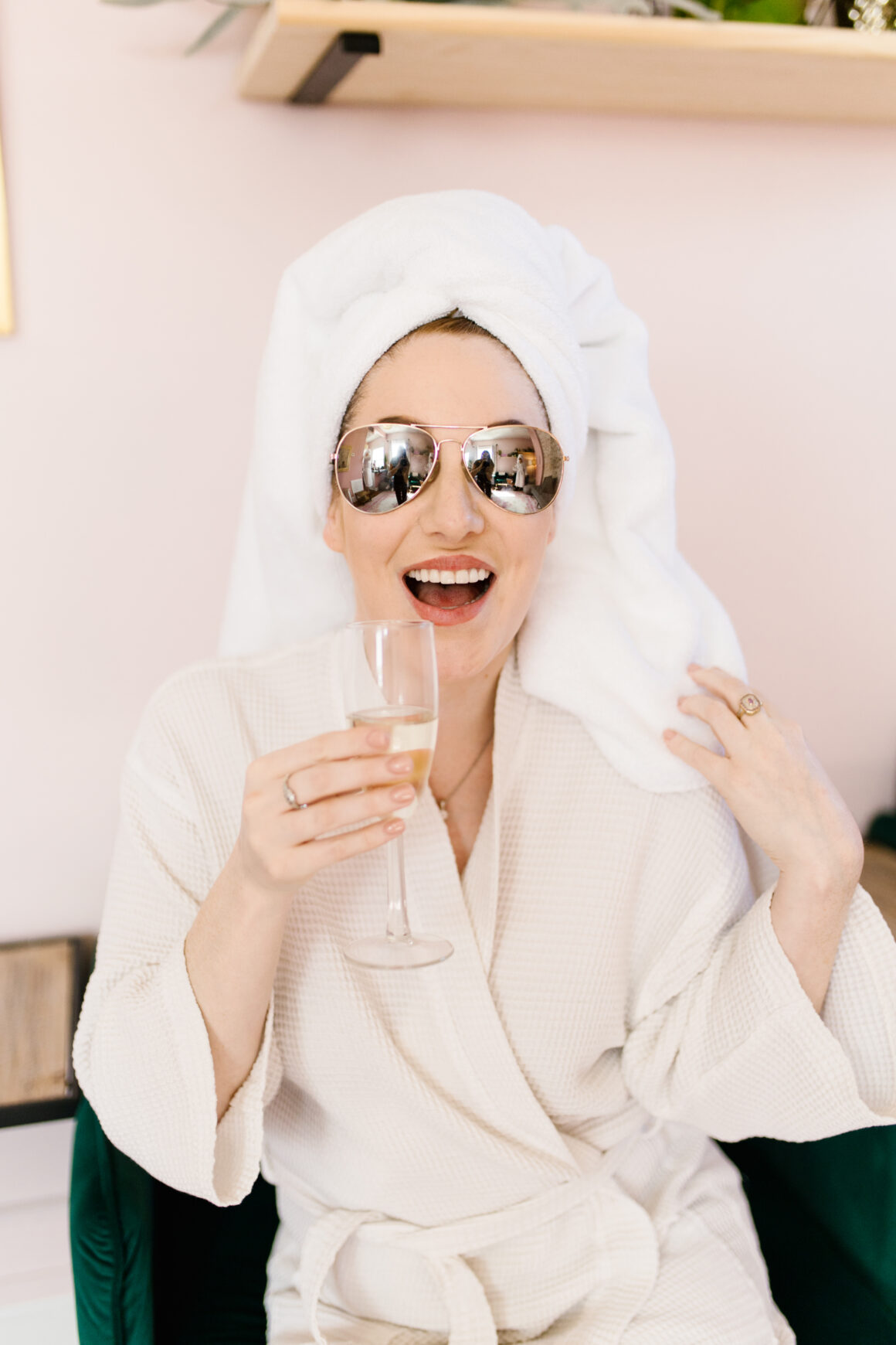 Woman enjoying a spa day at Urban Oasis Nashville, sipping champagne before her massage as part of the Mini Membership package