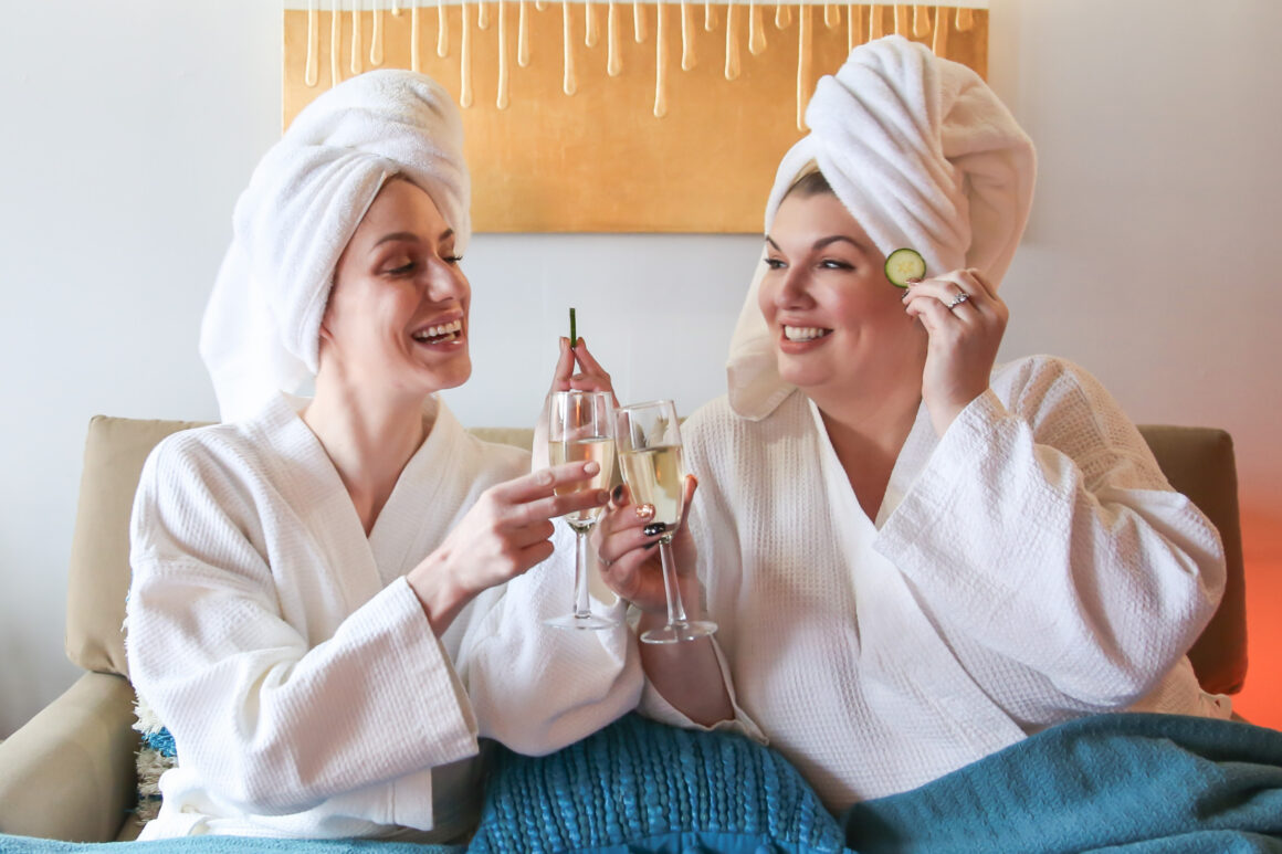 Two women enjoying a fun spa day together at Urban Oasis Nashville, relaxing and laughing during their Nashville spa experience.