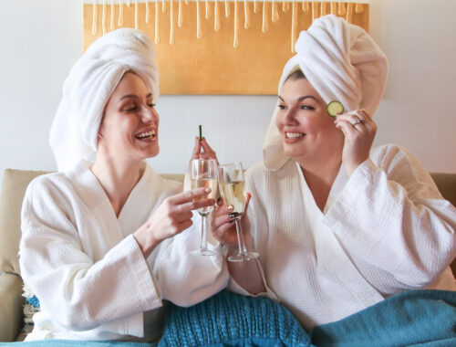Two women enjoying a fun spa day together at Urban Oasis Nashville, relaxing and laughing during their Nashville spa experience.