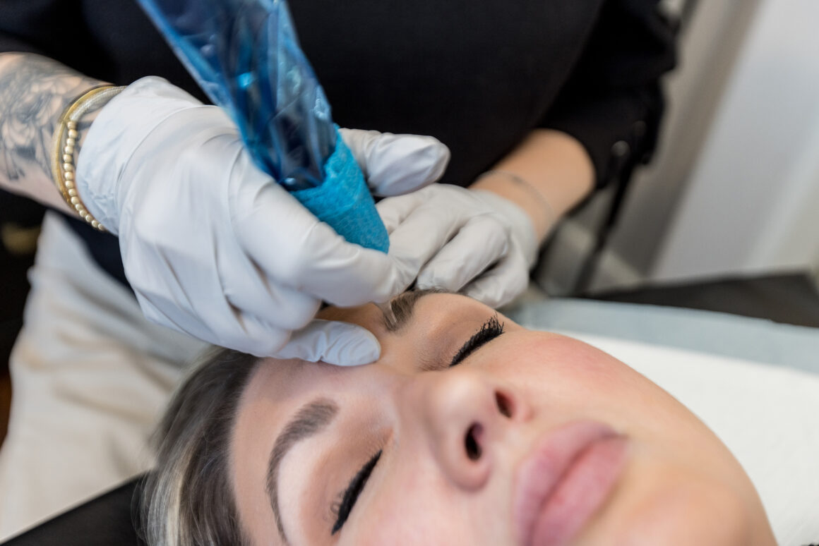 Client receiving a natural permanent makeup treatment at Urban Oasis Nashville, showcasing precise technique for brows, lips, or eyeliner.