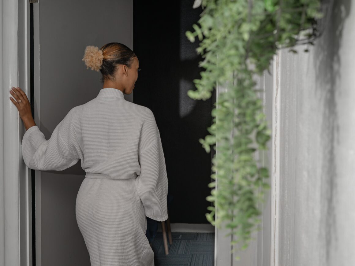Guest in a spa robe entering a private treatment room at a boutique day spa in Nashville