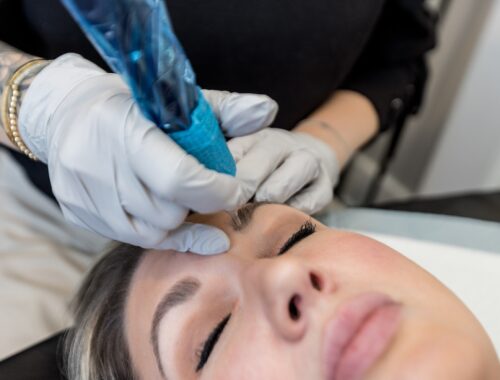 Permanent makeup artist performing Nano Brows treatment on client at Urban Oasis Nashville using digital machine technique.