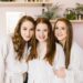 Women enjoying a spa day in Nashville at Urban Oasis wearing robes and smiling together