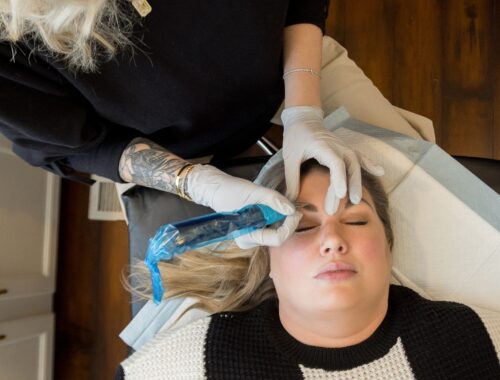 Licensed permanent makeup artist performing a customized nano brow procedure during a professional permanent makeup appointment at Urban Oasis Nashville.