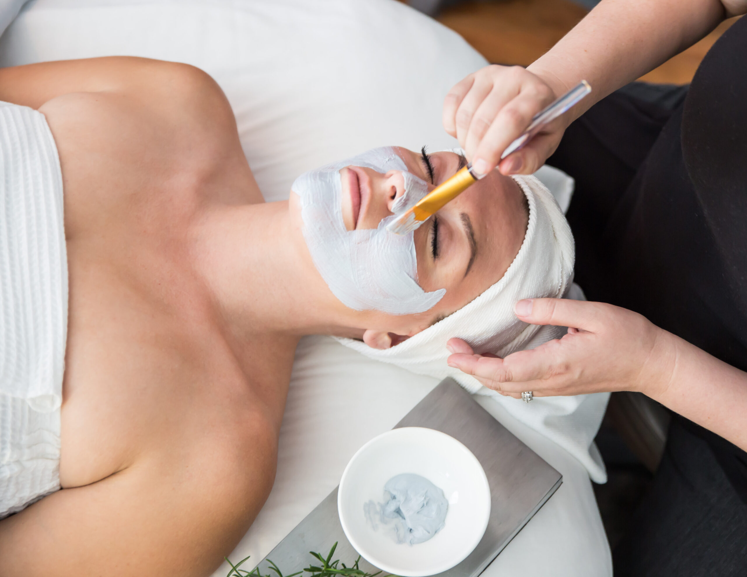 Licensed esthetician applying a Circadia facial mask during a customized professional facial at Urban Oasis Nashville.