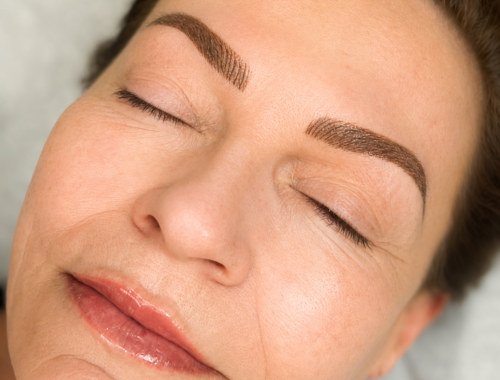 Client with nano combo brows and lip blush permanent makeup at Urban Oasis Nashville