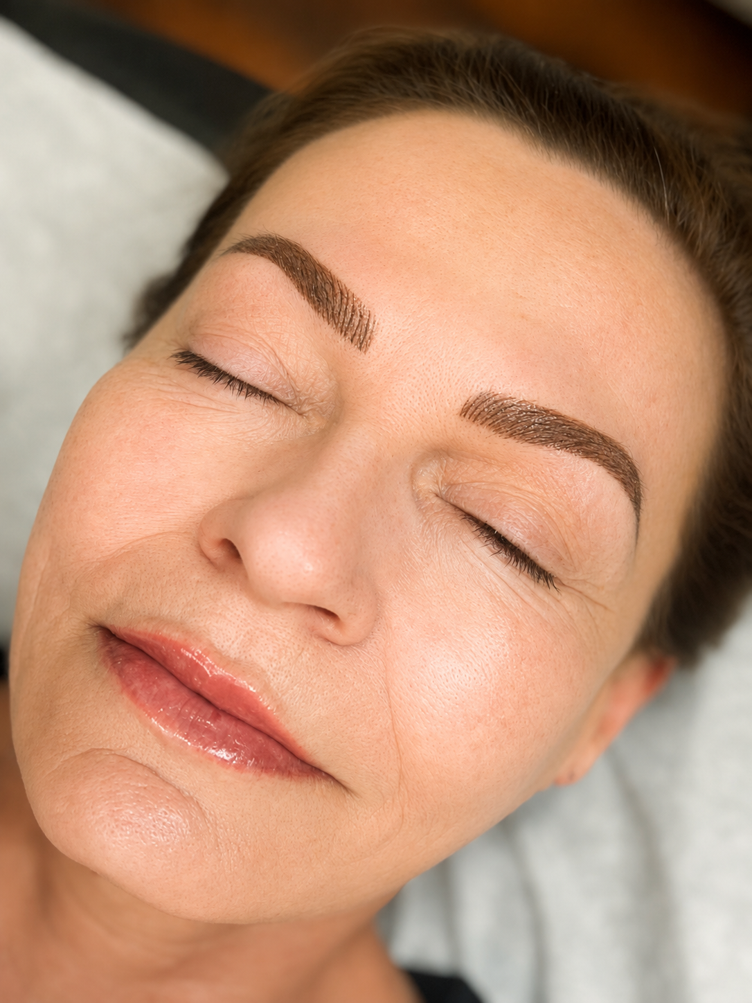 Client with nano combo brows and lip blush permanent makeup at Urban Oasis Nashville